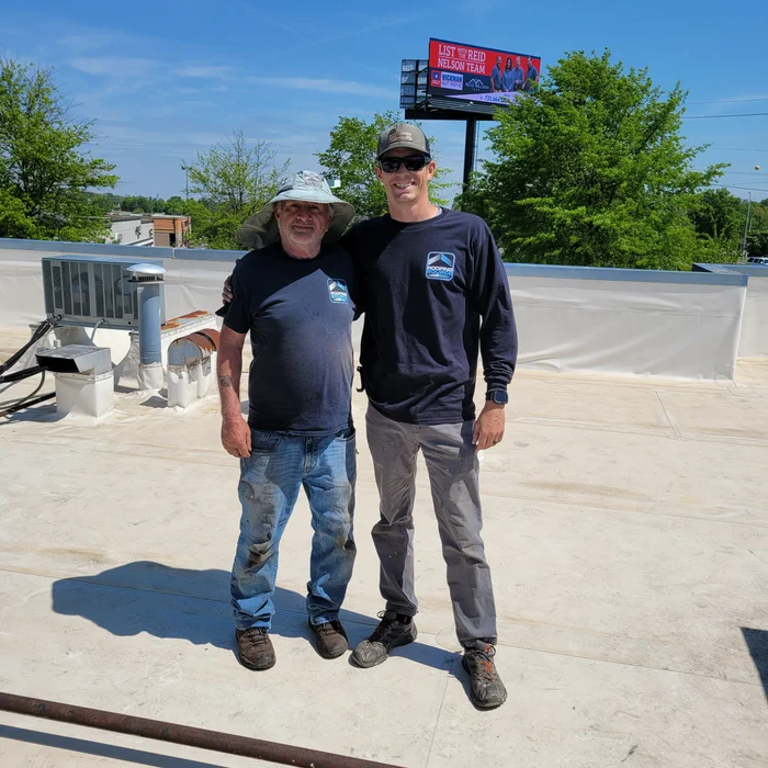 Two RoofingSource teammates on a commercial roof